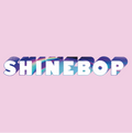 The word 'SHINEBOP' appears in large white letters with a holographic rainbow sheen and dark blue shadowing, centered on a solid light pink background.